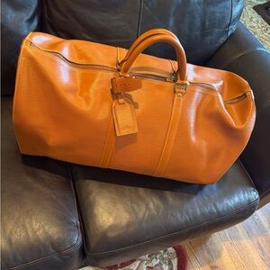 Elegant Louis Vuitton Epi Leather Keepall 55 in Cipango